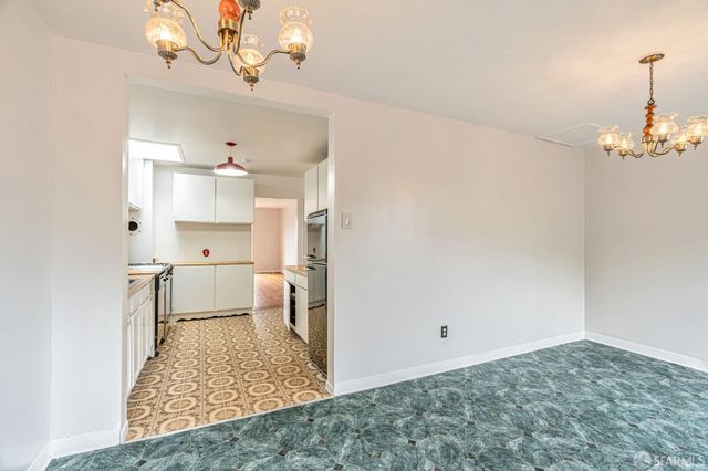an empty room with a window and wooden floor