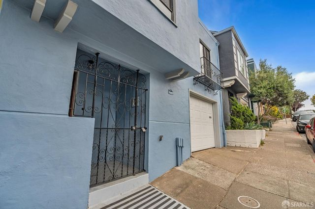 a view of a house with a wooden wall and door
