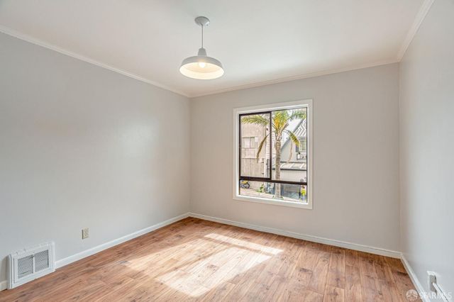 a view of walk in closet with empty racks