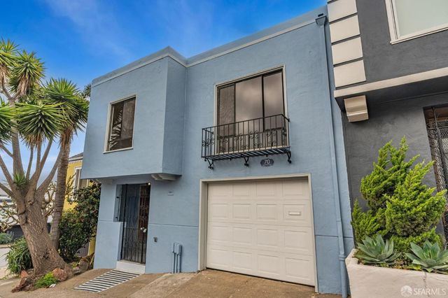 a front view of a house with garage