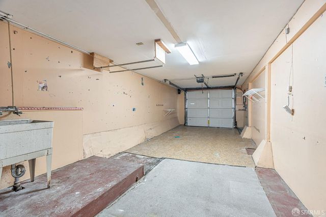 a view of a balcony with chairs and potted plants