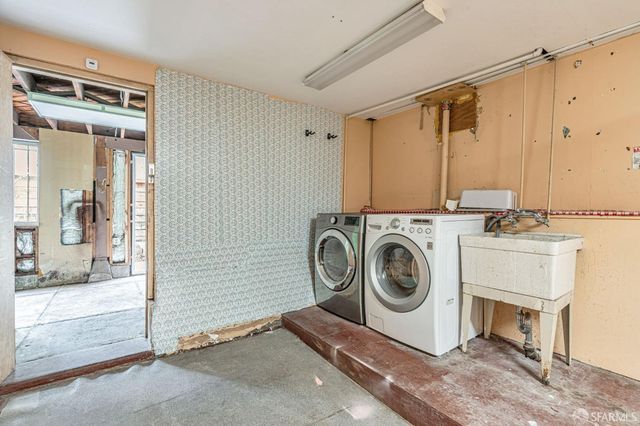 a view of a backyard with potted plants and wooden fence
