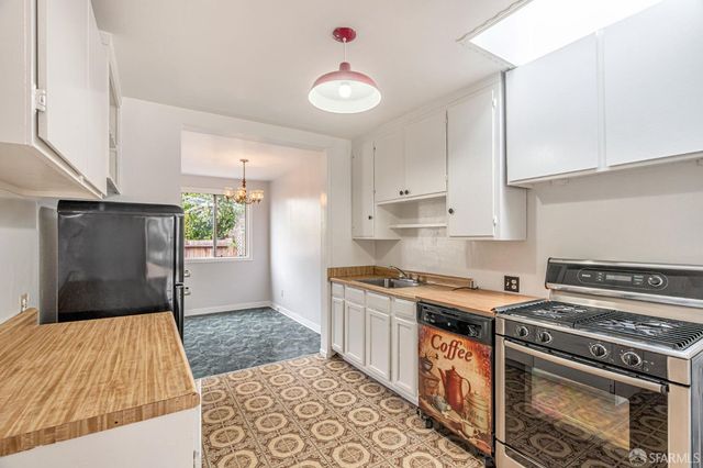 a kitchen with a stove and a refrigerator