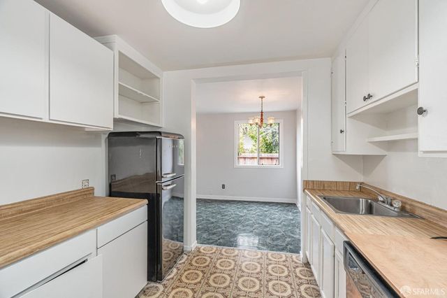 a kitchen with a stove a sink and a refrigerator