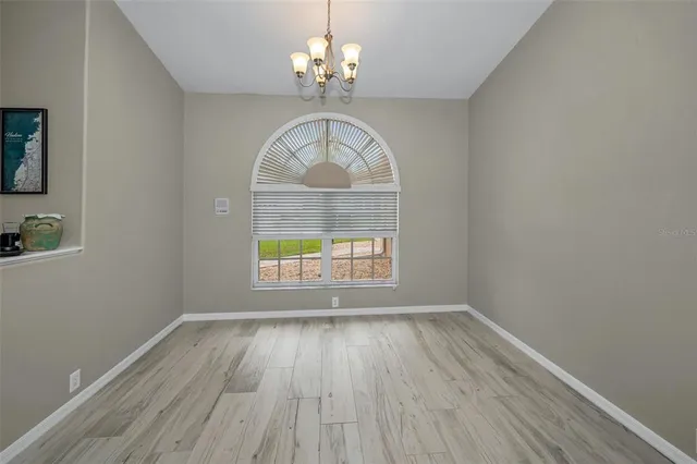 a kitchen with granite countertop white cabinets and stainless steel appliances