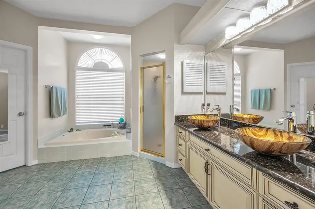 a bedroom with bed and a chandelier