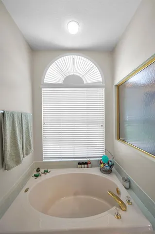a bedroom with bed and a chandelier
