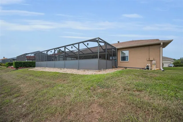 a swimming pool with outdoor seating and yard