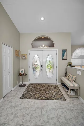 a living room with furniture a rug and white walls