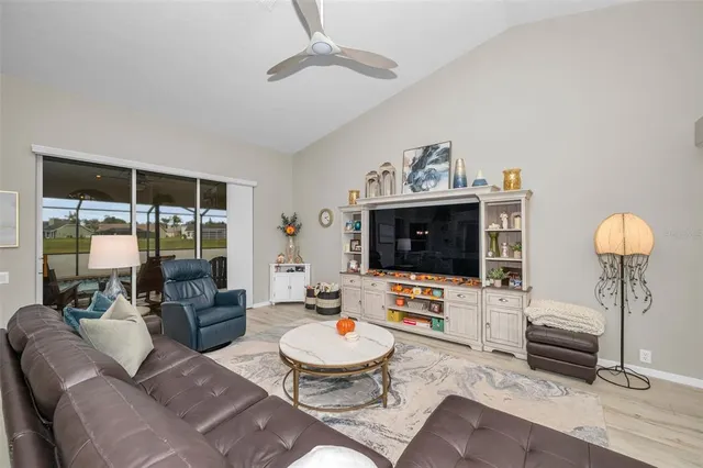 wooden floor in an empty room with a kitchen