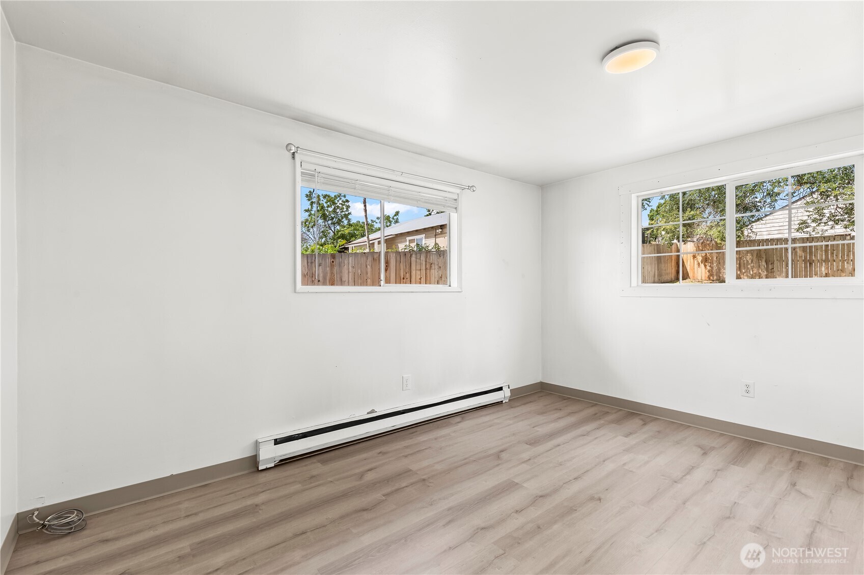 724 South Chelan Avenue Wenatchee, WA 98801 - Photo 16 of 20 an empty room with wooden floor and windows