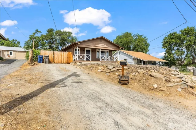 a view of a house with snow on the road