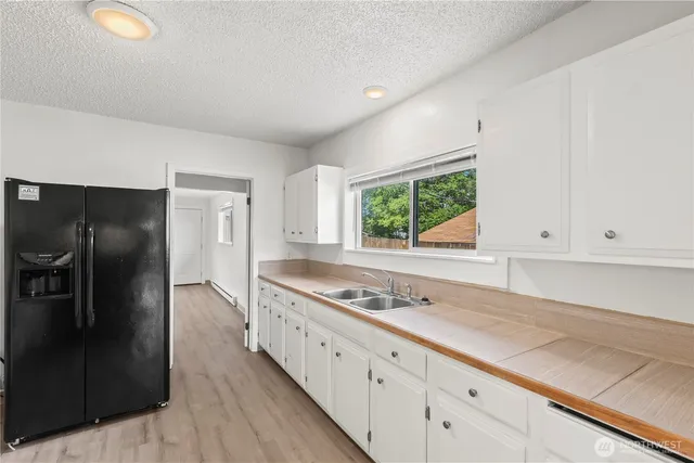 a kitchen with stainless steel appliances granite countertop a refrigerator and a stove