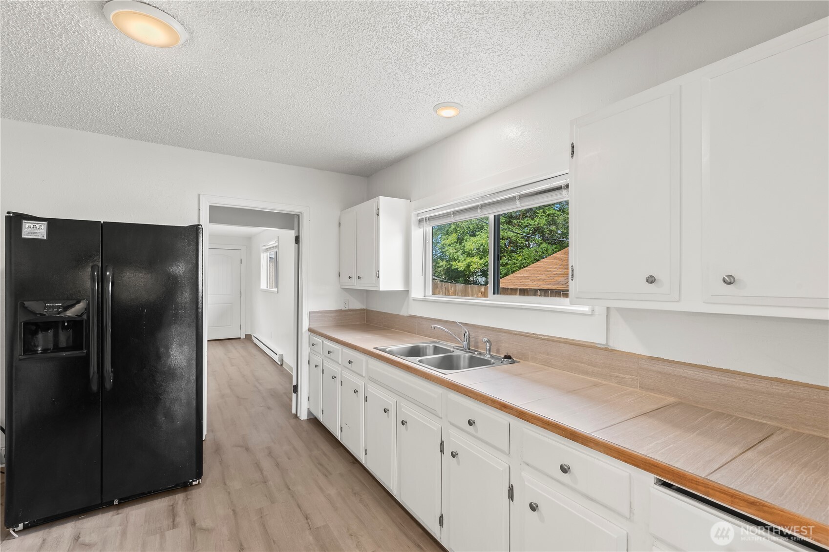724 South Chelan Avenue Wenatchee, WA 98801 - Photo 7 of 20 a kitchen with stainless steel appliances granite countertop a refrigerator and a stove