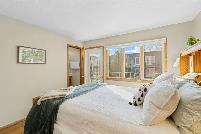 a bed sitting in a bedroom next to a window