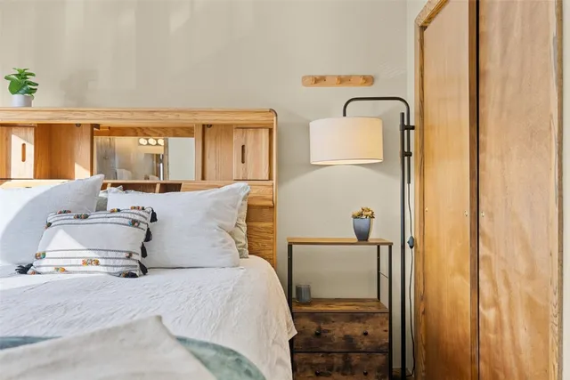 a bedroom with a large bed and a window