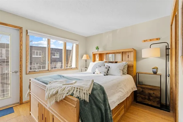 a bedroom with a bed and a large window