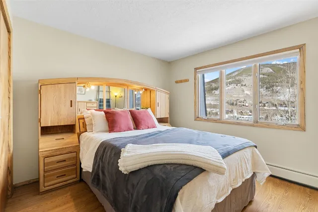 a bedroom with a bed and a large window