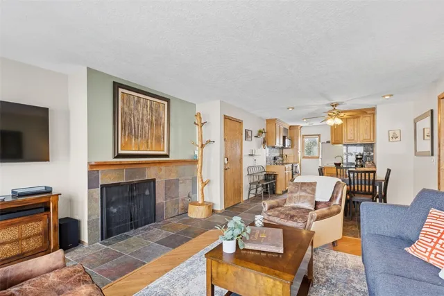 a living room with furniture fireplace and flat screen tv
