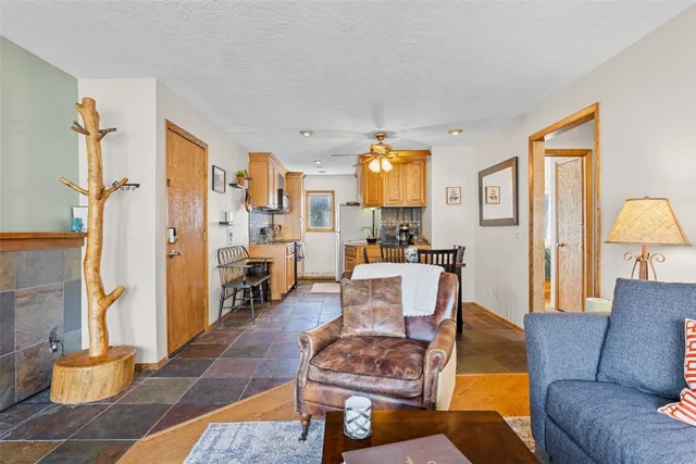 a living room with furniture a rug and a lamp
