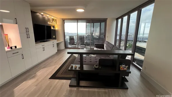 a view of a living room with furniture and a flat screen tv
