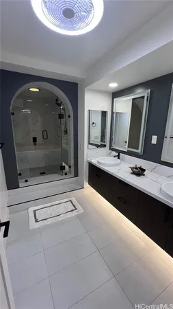 a spacious bathroom with a sink a mirror and bathtub
