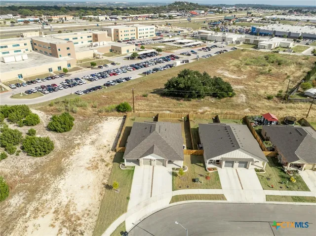 an aerial view of residential houses with outdoor space