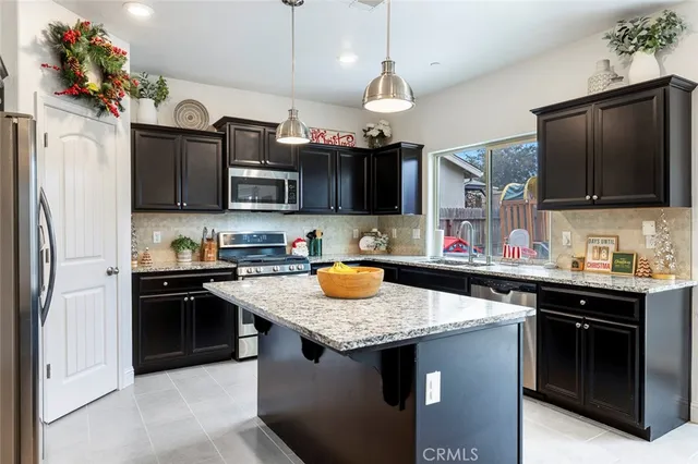 a kitchen with granite countertop a sink and a stove
