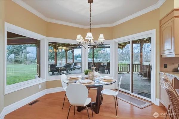a dining room with furniture large windows and outdoor view
