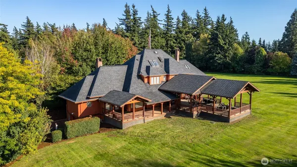 an aerial view of a house with swimming pool garden and outdoor seating
