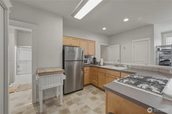 a kitchen with a refrigerator and a sink