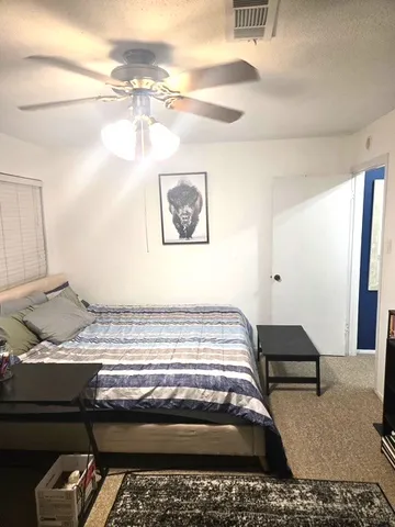 a view of a livingroom with furniture and floor to ceiling window