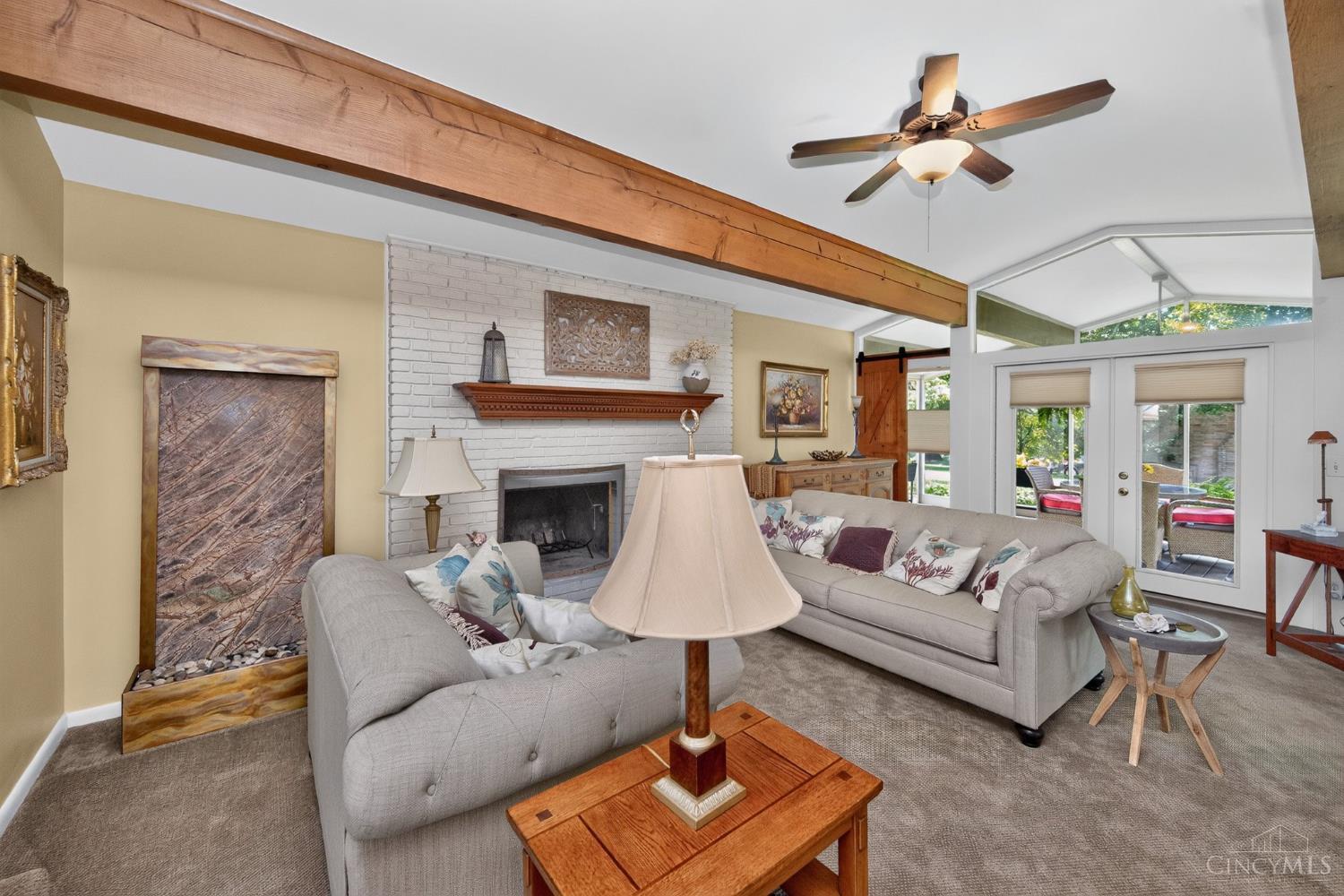 3078 Ebenezer Road Cincinnati, OH 45233 - Photo 6 of 51 The living room features a brick wood-burning fireplace, cathedral ceilings and ceiling fan.