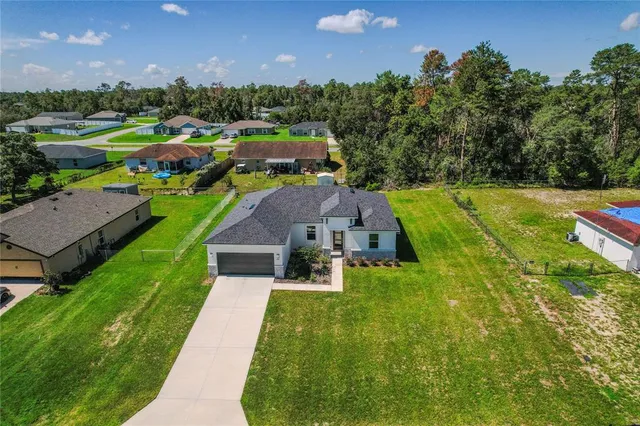 a view of yard with swimming pool and green space