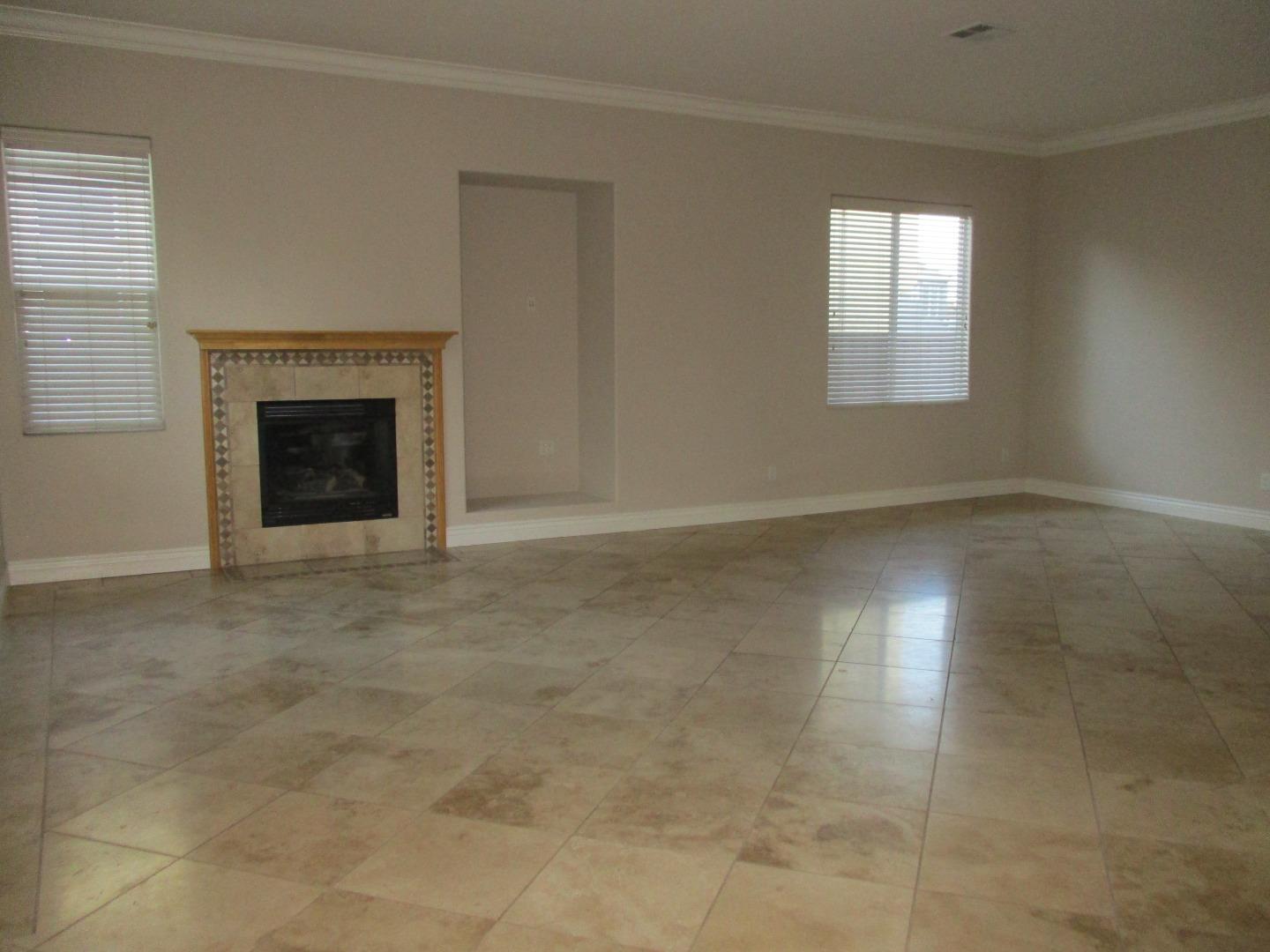 995 Brook Way Gilroy, CA 95020 - Photo 14 of 42 an empty room with windows and fireplace