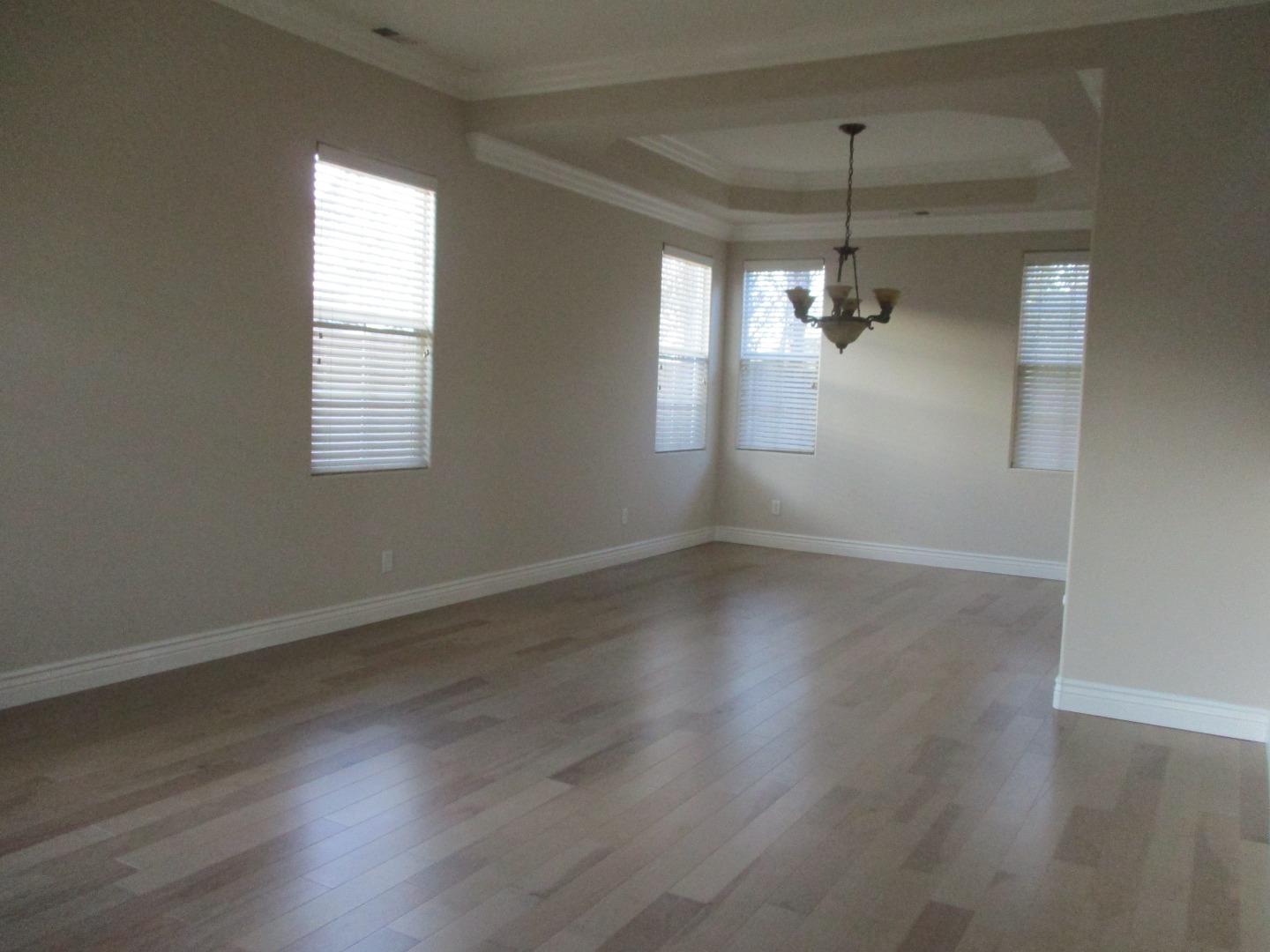 995 Brook Way Gilroy, CA 95020 - Photo 15 of 42 an empty room with wooden floor and windows