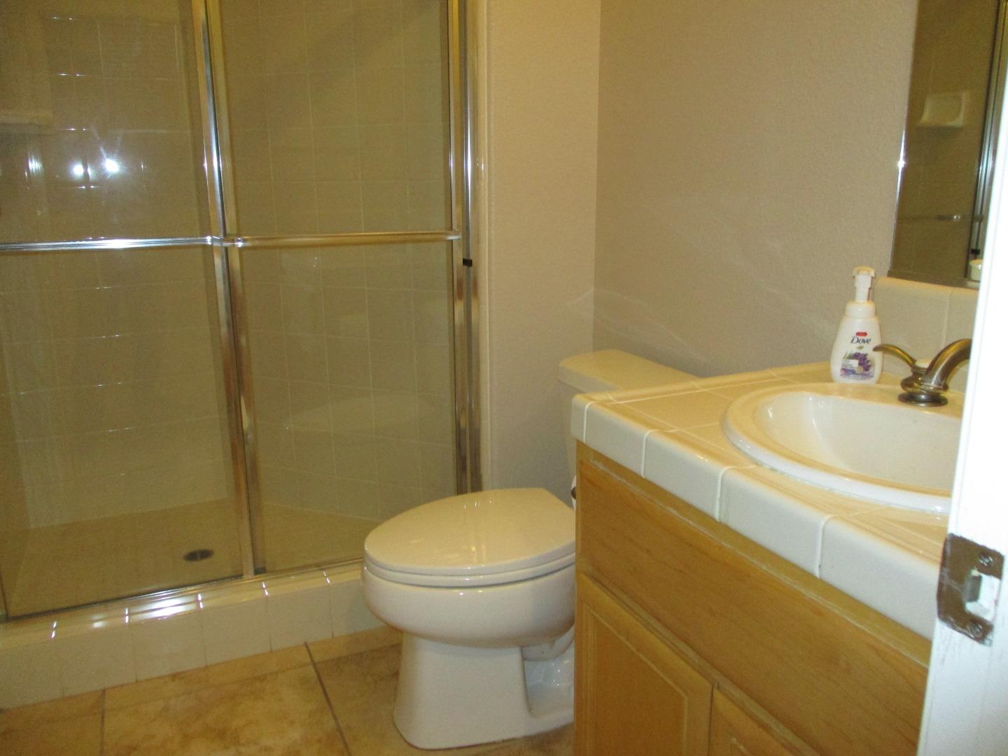 995 Brook Way Gilroy, CA 95020 - Photo 17 of 42 a bathroom with a sink a toilet and shower