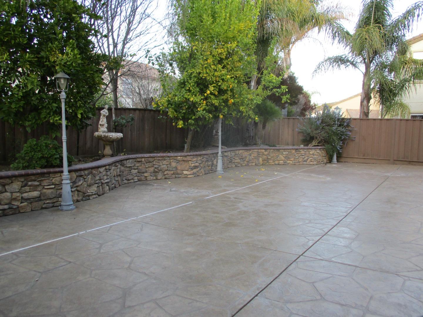 995 Brook Way Gilroy, CA 95020 - Photo 20 of 42 a view of a house with a backyard and a tree