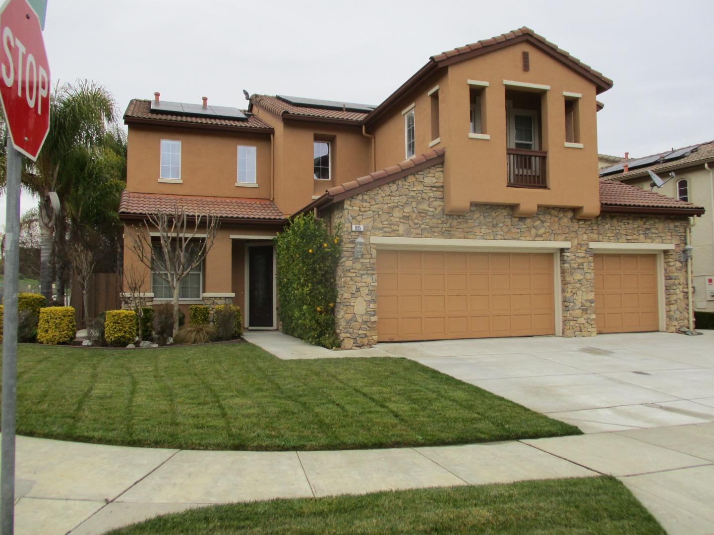 995 Brook Way Gilroy, CA 95020 - Photo 3 of 42 a front view of a house with a garden and yard