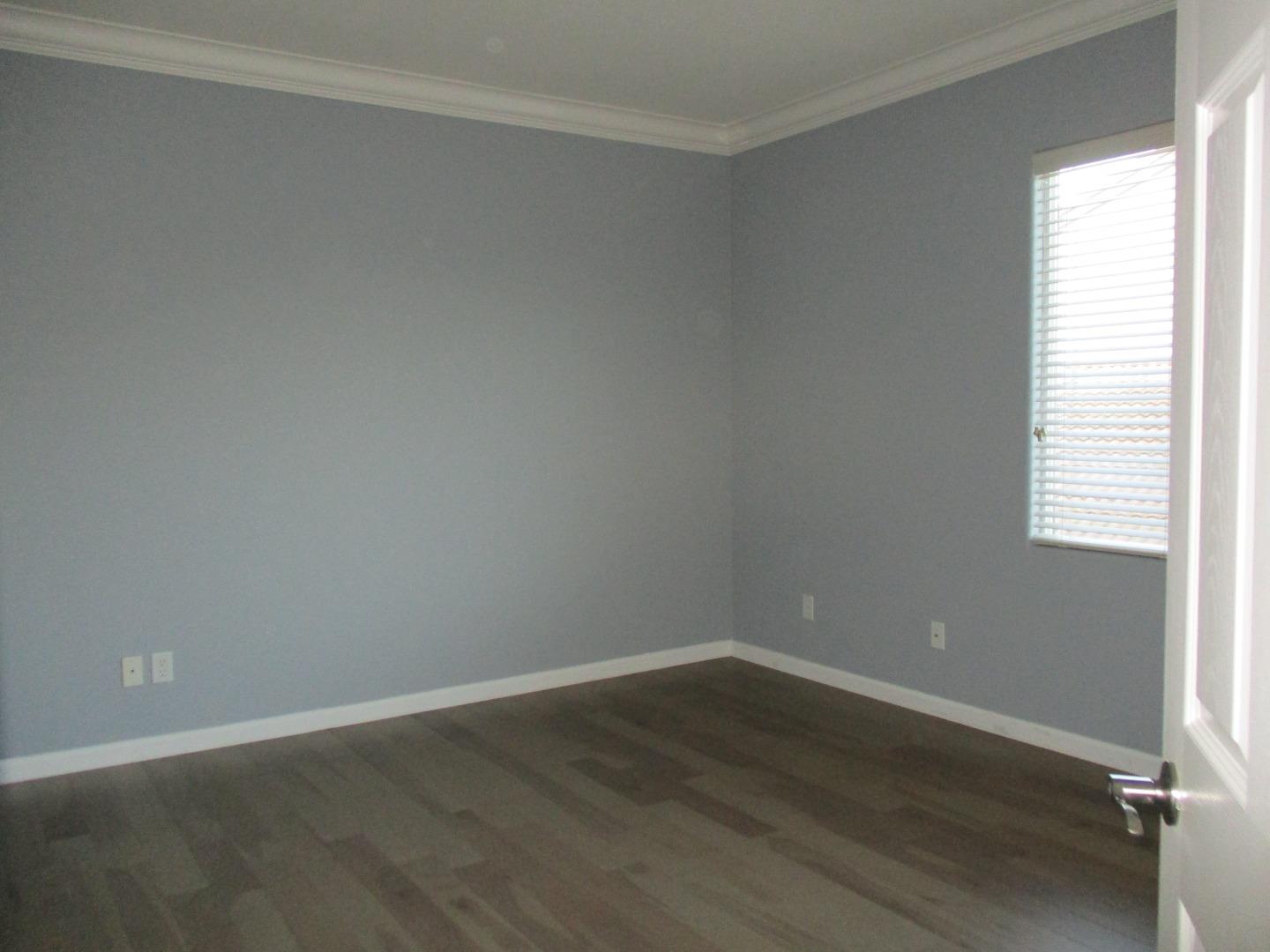 995 Brook Way Gilroy, CA 95020 - Photo 39 of 42 an empty room with wooden floor and windows