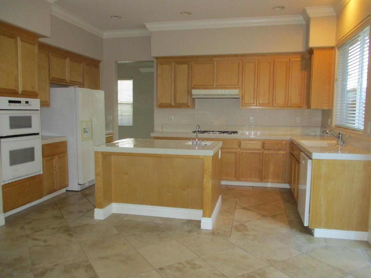 995 Brook Way Gilroy, CA 95020 - Photo 7 of 42 a view of a kitchen with a sink cabinets and a window
