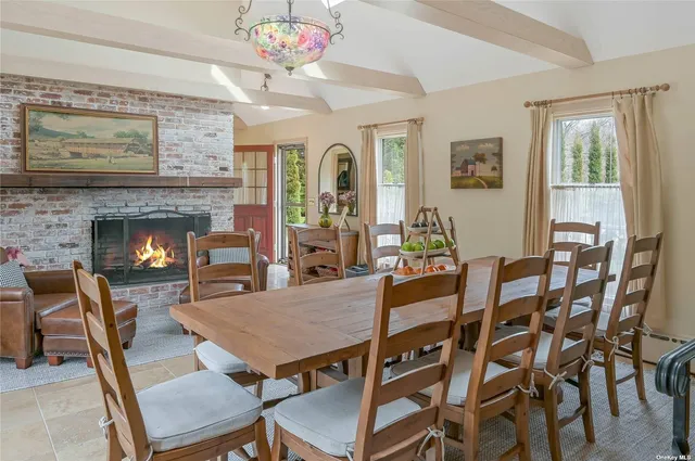 a view of a dining room with furniture and a fireplace