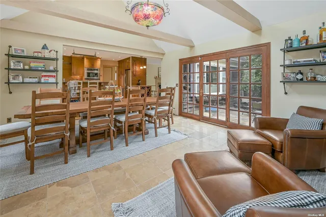 a living room with furniture a rug and a large window