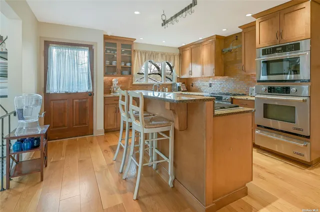 a kitchen with a table chairs stove and cabinets