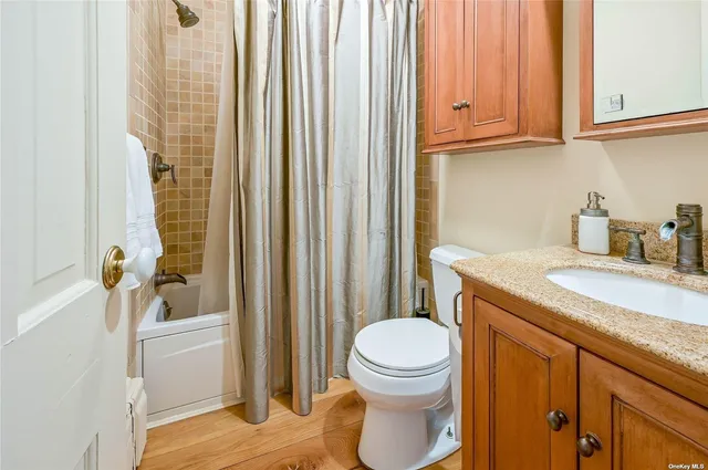 a bathroom with a sink a toilet and shower curtain