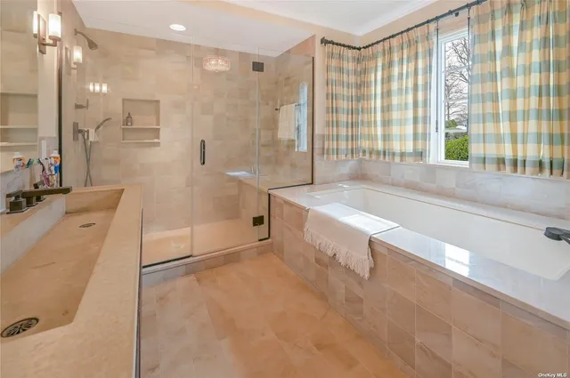 a spacious bathroom with a tub sink and shower