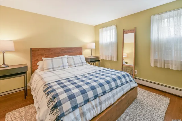 a bedroom with a bed and a night stand