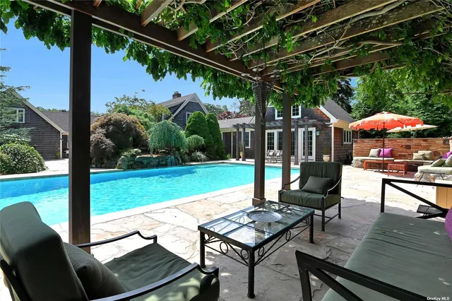 a view of an outdoor sitting area with furniture and umbrella