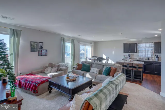 a living room with furniture kitchen and a table