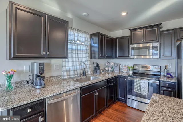 a view of a livingroom with furniture window and wooden floor
